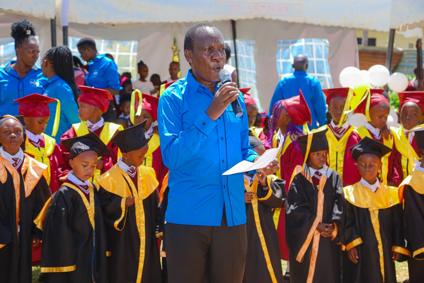 Pst. Walter Ong'ala addressing learners and parents at the graduation ceremony